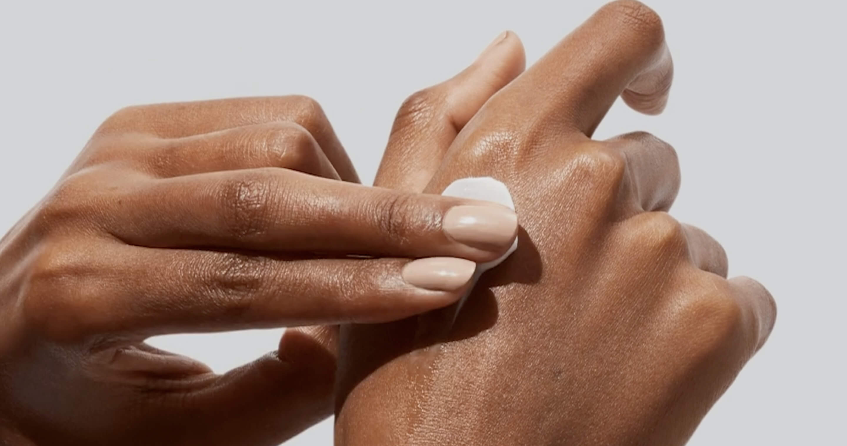 Hands applying cream