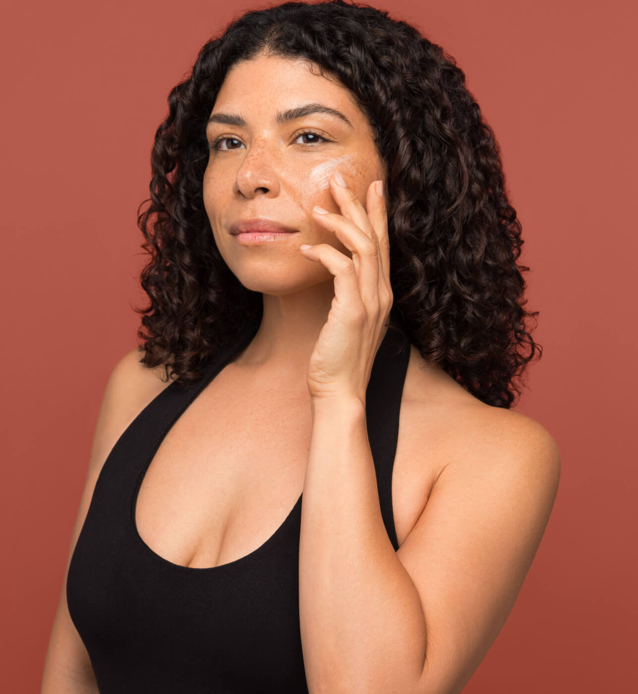 A woman applying serum
