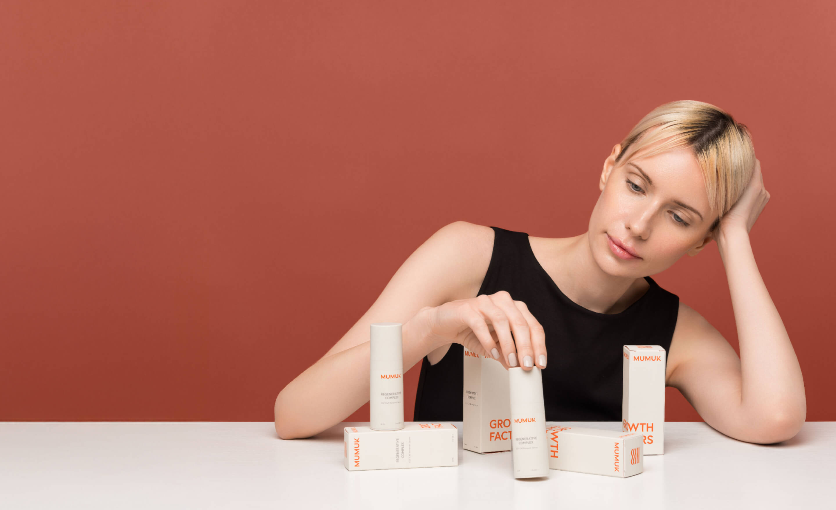 A woman with Mumuk bottles and packaging