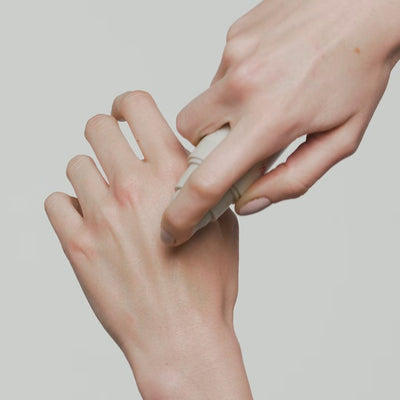 Close-up on hands applying Mumuk product